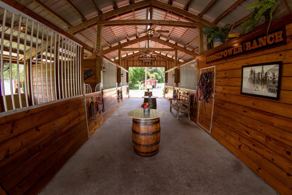 Barn breezeway with whiskey barrel at Horsepower Ranch